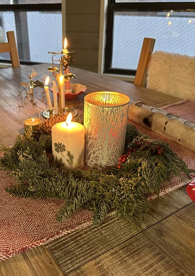 candles surrounded by a wreath at yule