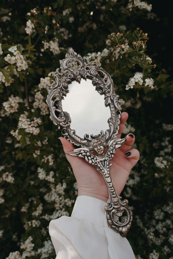 image of a mirror being held in a hand from unsplash